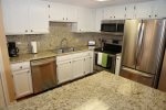 Stainless steel appliances and granite countertops in the kitchen, so nice.